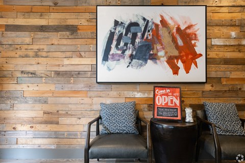 a living room with two chairs and an open sign